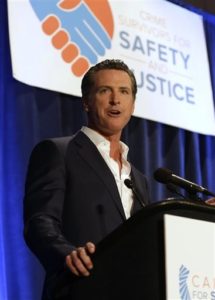 FILE -  In this April 20, 2015, file photo, Lt. Gov. Gavin Newsom speaks at the Californians for Safety and Justice conference in Sacramento, Calif. Newsom and a gun control advocacy group are proposing a 2016 ballot initiative to strengthen the state's gun laws by restricting ammunition sales, barring possession of large-capacity assault-style magazines and requiring gun owners to report lost or stolen guns to law enforcement. (AP Photo/Rich Pedroncelli, File)