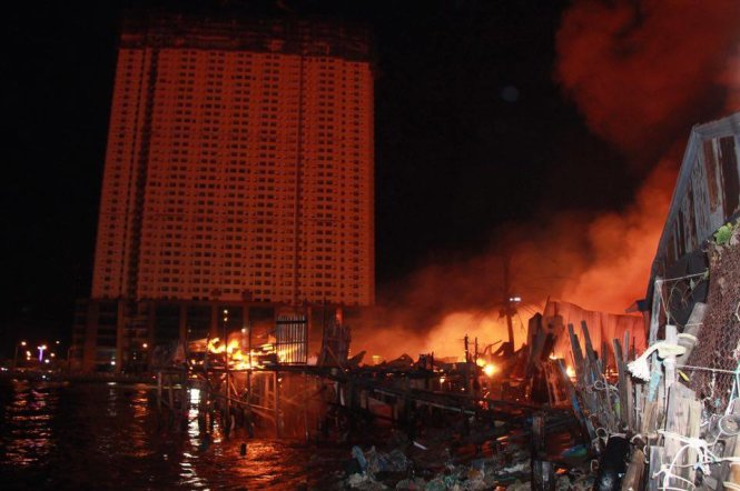 Đám cháy từ cồn Nhất Trí bên cạnh tòa nhà cao tầng Mường Thanh. Ảnh: Tuổi Trẻ